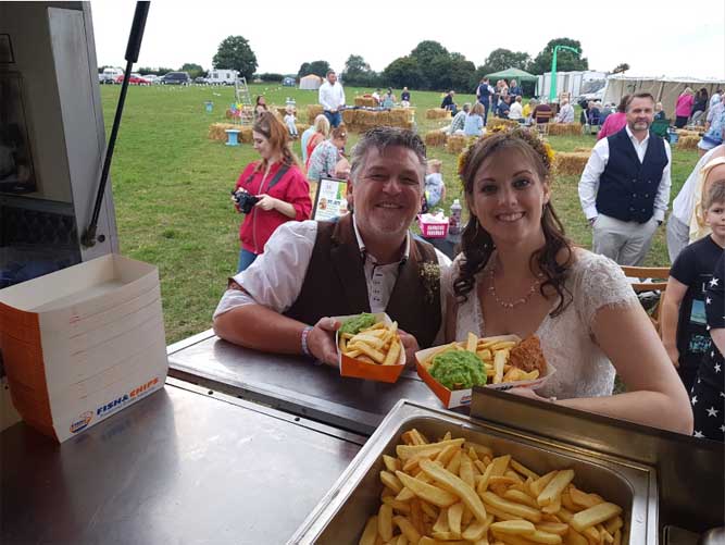 bride and groom with fish and chips at there wedding