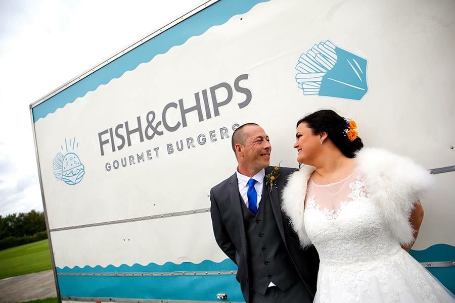 Bride and groom outside fish and chip van