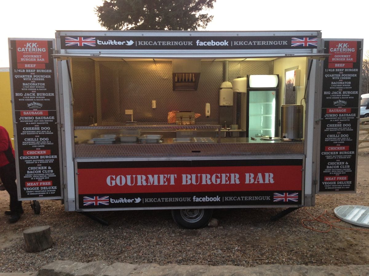 Red and black gourmet burger van set up at event