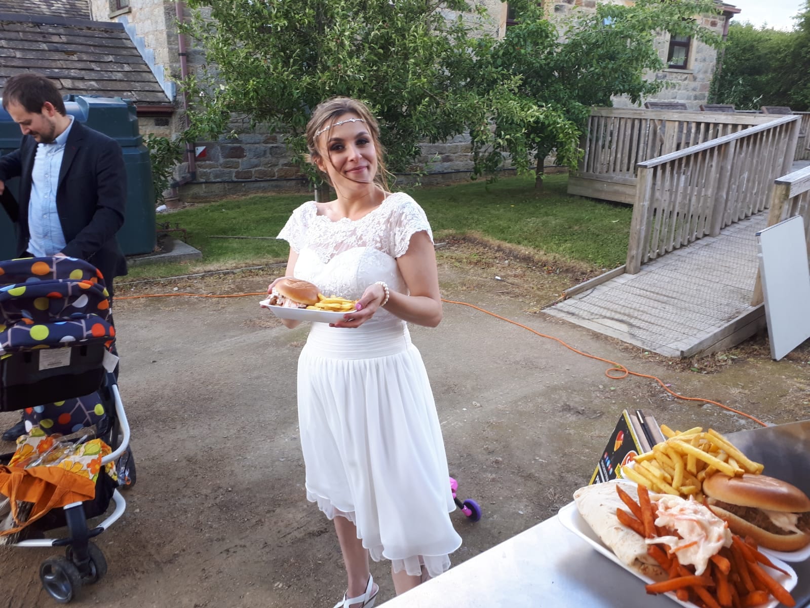 Bride holding a plate with burger and fries