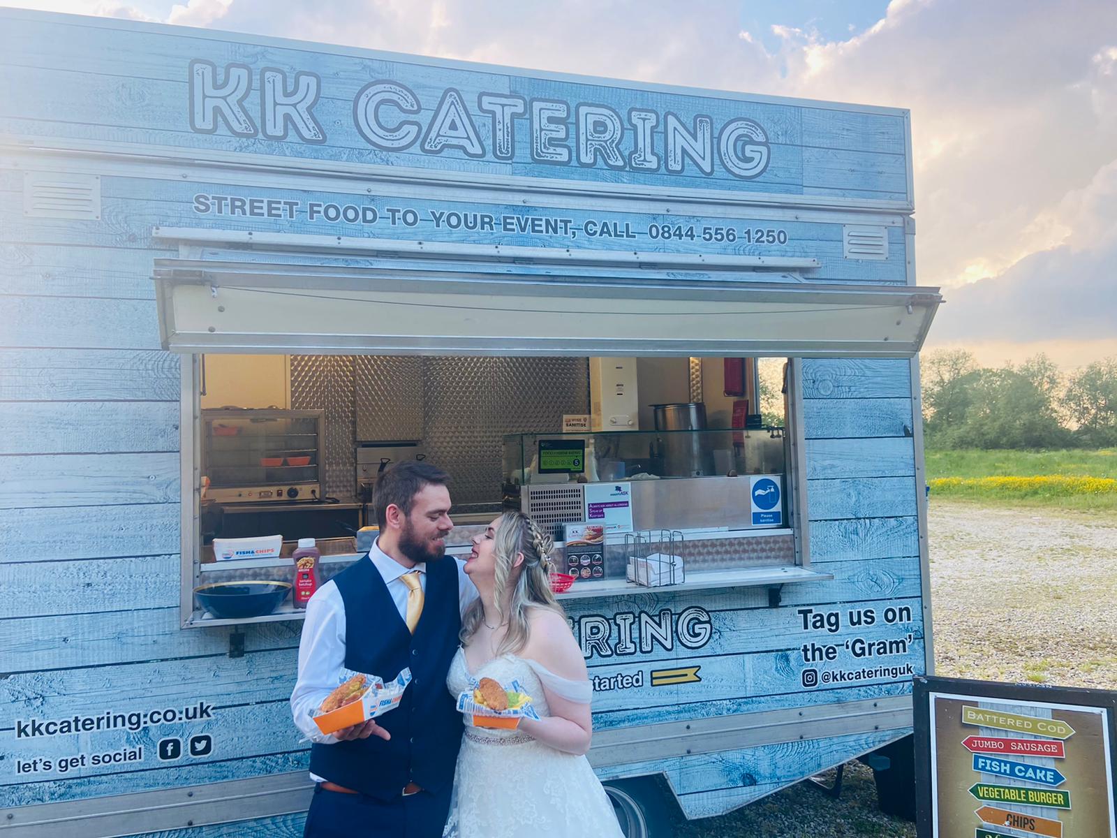 Bride and groom with fish and chips at kk catering fish and chip van