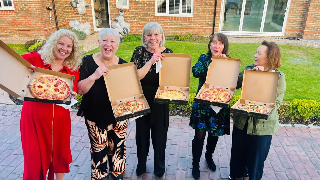 ladies collecting their pizzas from the kk catering pizza van