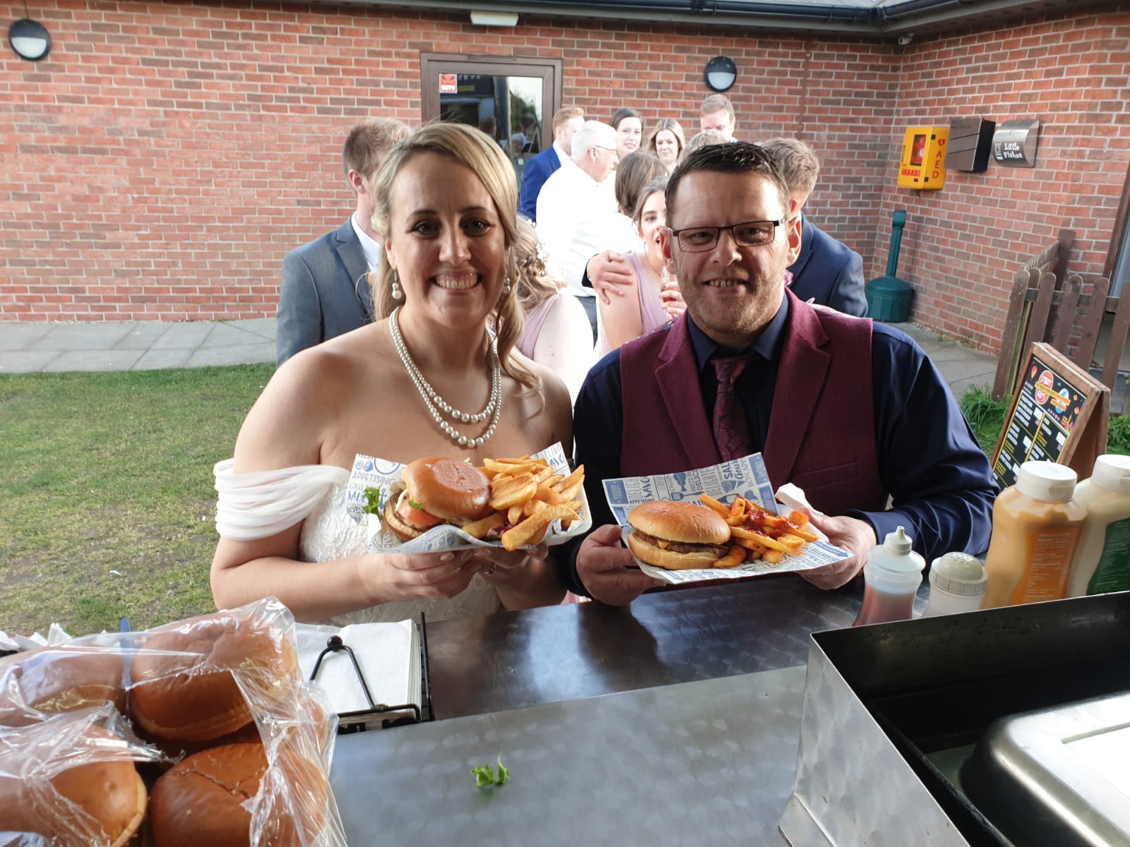 Bride and Groom with Burgers on their wedding day