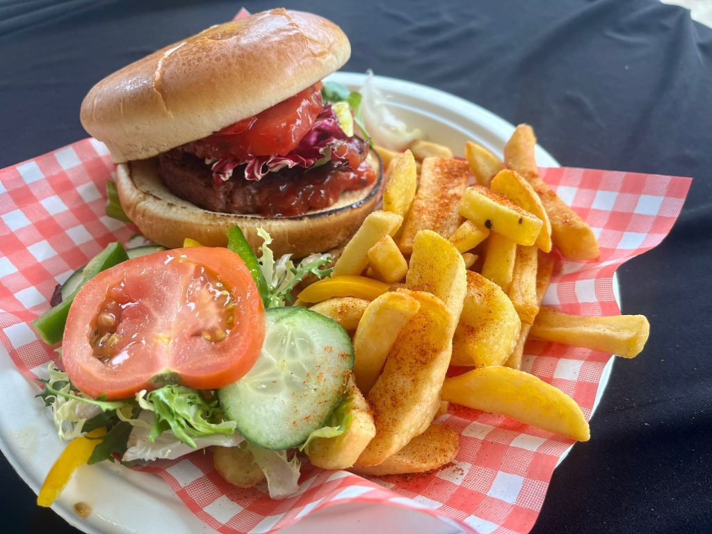 a vegan plant based burger with chips and salad